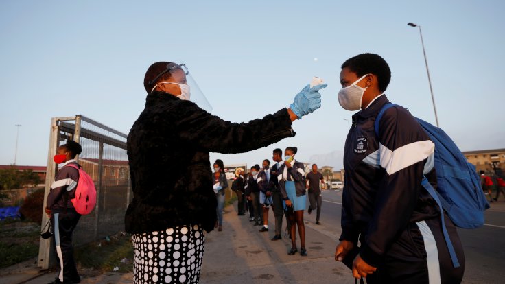 FILE PHOTO: A learner is screened as schools begin to reopen after the coronavirus disease (COVID-19) lockdown in Langa township in Cape Town, South Africa June 8, 2020. REUTERS/Mike Hutchings/File Photo