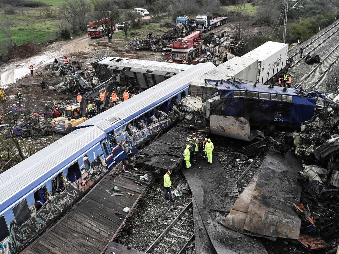 Police and emergency crews examine the debris of a crushed wagon on the second day after a train accident in the Tempi Valley near Larissa, Greece, March 2, 2023. - At least 46 people were killed and another 85 injured after a collision between two trains caused a derailment near the Greek city of Larissa late at night on February 28, 2023, authorities said. A fire services spokesman confirmed that three carriages skipped the tracks just before midnight after the trains -- one for freight and the other carrying 350 passengers - collided about halfway along the route between Athens and Thessaloniki. (Photo by Sakis MITROLIDIS / AFP) (Photo by SAKIS MITROLIDIS/AFP via Getty Images)